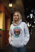 Featuring a stunning lake scene with a vibrant sunset, this hoodie captures the beauty of Lake of the Woods in Ontario, where tranquil waters meet the warm glow of a setting sun.
